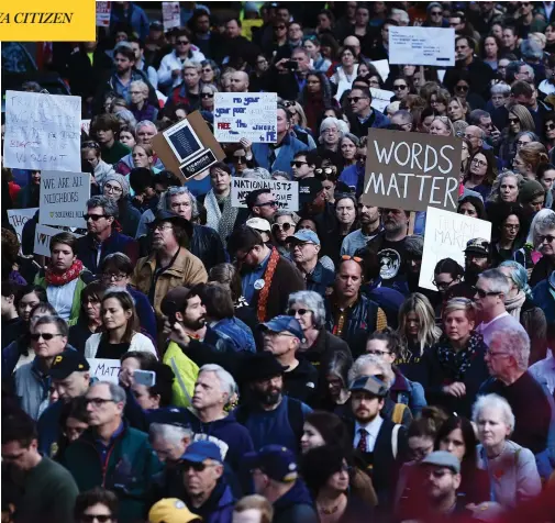  ?? BRENDAN SMIALOWSKI / AFP / GETTY IMAGES ?? People protesting against President Donald Trump gather near the Tree of Life synagogue Tuesday in Pittsburgh, Penn. Funerals were held on Tuesday for four of the victims of the anti-Semitic attack that left 11 worshipper­s dead on Saturday.