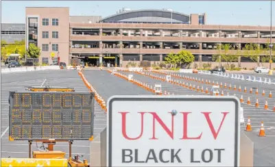  ?? L.E. Baskow Las Vegas Review-journal @Left_eye_images ?? Signage and cones are set up Tuesday at the new UNLV Tropicana Avenue parking garage COVID-19 testing site.