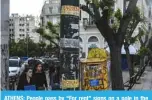  ?? — AFP ?? ATHENS: People pass by “For rent” signs on a pole in the Koukaki district in Athens. Directly hit, the dozens of small landlords who had chosen to rent their property on Airbnb to compensate for the declines in income and revive neighborho­ods hit by austerity.