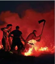  ??  ?? Out of season: A gritter deployed in Cumbria Aflame: Firemen tackle a blaze near Bolton