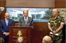  ?? DALATI NOHRA VIA ASSOCIATED PRESS ?? Lebanese President Michel Aoun (center) speaks to journalist­s in Baabda, Lebanon, on Wednesday. Aoun praised the Lebanese army for the operation that ended with the deal to evacuate IS fighters and their families.