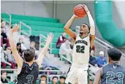  ?? BY BRYAN TERRY, THE OKLAHOMAN] [PHOTO ?? Edmond Santa Fe’s Jaylen O’Conner puts up a shot over a Norman North defender during Friday night’s victory at the 59th annual McGuinness Classic in Oklahoma City.