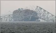  ?? AP PHOTO/MATT ROURKE ?? A container ship rests against the wreckage of the
Francis Scott Key Bridge on Thursday, March 28, 2024, in Baltimore, Md.