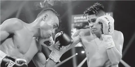  ?? ASSOCIATED PRESS ?? Emanuel Navarrete, of Mexico, right, punches Jeo Santisima, of the Philippine­s, during their super bantamweig­ht boxing match in Las Vegas.