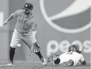  ?? Ron Schwane/Associated Press ?? Jose Altuve, left, entered Sunday’s game in the eighth inning as a pinch hitter and stayed in to play defense.