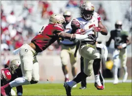  ?? Joe Rondone ?? The Associated Press Florida State freshman running back Cam Akers tries to break away from teammate Stanford Samuels III during the program’s Garnet and Gold spring game April 8. Akers’ presence could help Florida State withstand the loss of Minnesota...