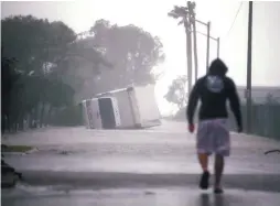  ??  ?? A truck is seen turned over in Miami as Hurricane Irma passes south Florida yesterday.