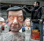  ?? PHOTO: REUTERS ?? A worker put the final touches to a giant figure of Francois Fillon during preparatio­ns for the carnival parade in Nice, France.