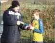  ??  ?? Peter Porter presents Michael O’Brien with the shield trophy.