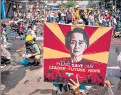  ?? JUNTA COURT VERDICT ?? A protester holds a poster featuring detained civilian leader Aung San Suu Kyi in Yangon, Myanmar.