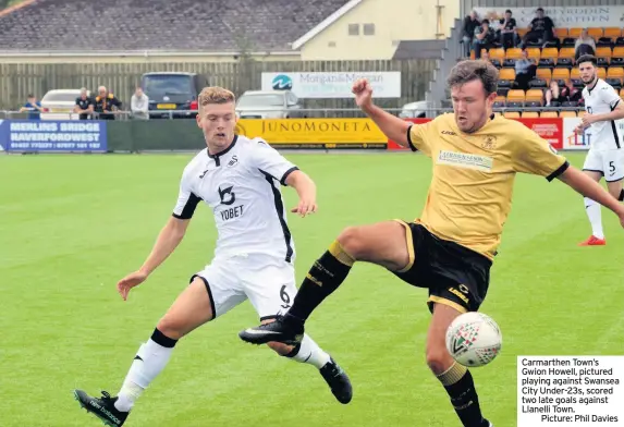  ??  ?? Carmarthen Town’s Gwion Howell, pictured playing against Swansea City Under-23s, scored two late goals against Llanelli Town.
Picture: Phil Davies