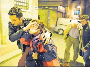  ?? AP PHOTO ?? People believed to be German tourists that were targeted at an explosion in the historic Sultanahme­t district are escorted back to their hotel in Istanbul Tuesday.