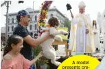  ?? — AFP ?? A dog blessed with holy water during annual Blessing of the Animals ceremony, presided over by Archbishop Jose H. Gomez, in Los Angeles, on Sunday.