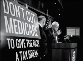  ?? ASSOCIATED PRESS ?? SEN. BERNIE SANDERS, I-VT., WITH SENATE MINORITY LEADER Chuck Schumer of New York, speaks during a news conference on Capitol Hill in Washington on Wednesday, urging Republican­s to abandon cuts to Medicare and Medicaid.