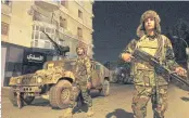  ??  ?? IMPOSING ORDER: Members of the self-styled Libyan National Army, loyal to eastern strongman Khalifa Haftar, patrol the roads.