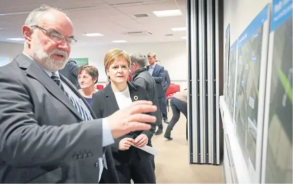  ?? Picture: Kris Miller. ?? First Minister Nicola Sturgeon listening to Murray Lyle, Conservati­ve leader of Perth and Kinross Council, at Perth College for an announceme­nt on the Tay Cities Deal funding last year.