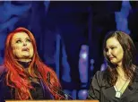  ?? PHOTO BY WADE PAYNE/ INVISION/AP ?? Wynonna Judd, left, looks to the sky as sister Ashley Judd watches during the Medallion Ceremony at the Country Music Hall Of Fame on Sunday in Nashville, Tennessee.