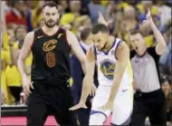  ?? MARCIO JOSE SANCHEZ — THE ASSOCIATED PRESS ?? Golden State Warriors guard Stephen Curry celebrates in front of Cleveland Cavaliers forward Kevin Love (0) during the second half of Game 1 of basketball’s NBA Finals in Oakland Thursday.