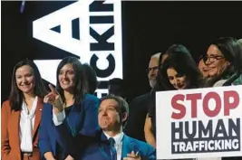  ?? COURTESY ?? Gov. Ron DeSantis throws a pen which he used to sign an anti-human traffickin­g bill to the crowd on Tuesday at the Coastal Communtiy Church in Lighthouse Point.