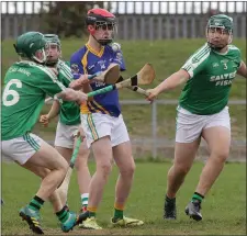  ??  ?? Martin Doyle of Clúain O’Rahilly’s is surrounded by defenders.