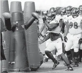  ?? KIM HAIRSTON/BALTIMORE SUN ?? Defensive tackle Timmy Jernigan performs a tackling drill at training camp Saturday. He walked off the field later with what is being diagnosed as a minor rib injury.