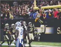  ?? The Associated Press ?? HIGH FLYING: New Orleans Saints defensive end Cameron Jordan (94) celebrates his touchdown after intercepti­on in the end zone in Sunday’s game against the Detroit Lions in New Orleans.