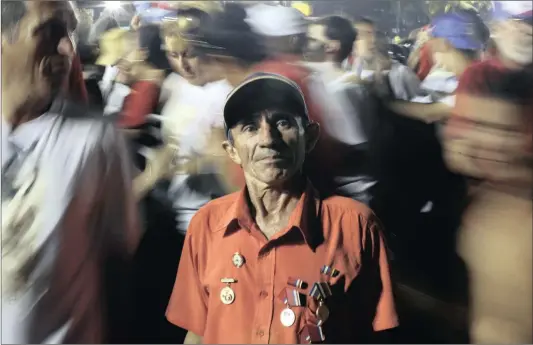  ?? Picture: REUTERS ?? JUVENTINO Pascal poses for a photo as people cheer around him during a tribute to former Cuban leader Fidel Castro in Santiago, Cuba.