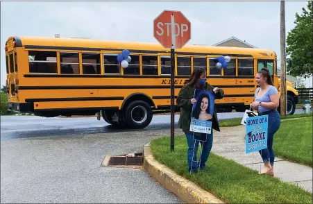  ?? SUBMITTED PHOTO — CORY DERER ?? Daniel Boone School Board President Julia Olafson congratula­tes Boone Class of 2020senior Katrina Robbins during the surprise parade for graduates on May 22. Decorated vehicles and buses visited each senior’s home.