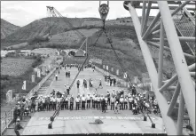  ?? XU GUO / FOR CHINA DAILY ?? China Tiesiju Civil Engineerin­g Group employees complete the closure of the Yuanjiang Super Railway Bridge in Yunnan province on Wednesday.