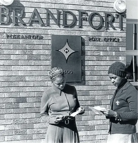  ?? Picture: Tiso Blackstar Group Archive ?? OVERSEAS GREETINGS Winnie Mandela stands outside the Brandfort post office on July 18 1978 with her daughter Zindzi, holding messages from all over the world to commemorat­e the 60th birthday of her husband, Nelson Mandela, who was then still in jail on...