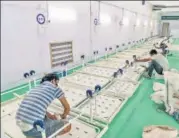  ?? BLOOMBERG ?? Workers assemble beds in the Covid-19 ICU annexe of LNJP Hospital at the Ramlila Maidan in New Delhi on Friday.