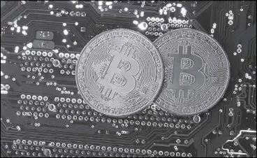  ?? REUTERS ?? Copies of bitcoins standing on PC motherboar­d are seen in this illustrati­on picture.