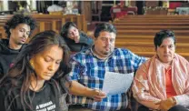  ?? Amr Alfiky / Associated Press ?? Attorney Roberto Lopez, center, and pastor Jacobita Cortes attend a meeting on how to protect migrants in Chicago.