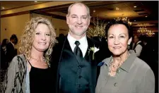  ??  ?? Johnny Hoelzeman, father of the groom, with (from left) his
wife, Staci, and his mother, Pat Hoelzeman