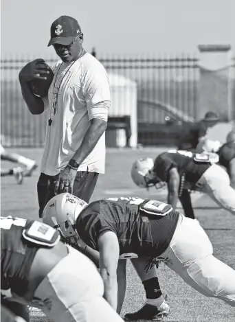  ?? PAUL W. GILLESPIE/CAPITAL GAZETTE ?? Two days after being fired, Navy’s Ivin Jasper, shown during practice on Aug. 12, was brought back to the Navy football coaching staff as quarterbac­ks coach.