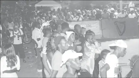  ??  ?? Sections of the massive crowd that witnessed the round of 16 and quarter-final action in the Guinness Cage Streetball Championsh­ip at the Haslington Tarmac.