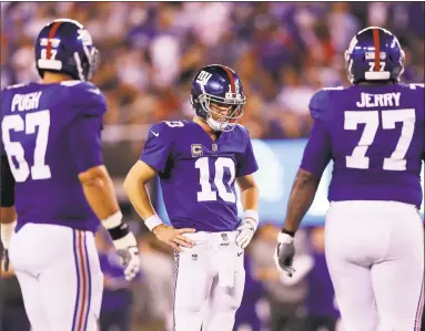  ?? Elsa /Getty Images ?? Giants quarterbac­k Eli Manning looks on in the fourth quarter against the Detroit Lions on Monday night in East Rutherford, N.J.