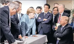  ?? PICTURE: REUTERS ?? German Chancellor Angela Merkel speaks to US President Donald Trump during the second day of the G7 meeting in Charlevoix city of La Malbaie, Quebec, Canada, on Saturday.