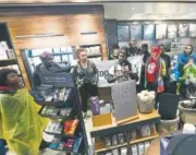  ??  ?? Demonstrat­ors occupy the Starbucks that has become the center of protests Monday in Philadelph­ia.