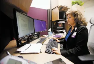  ??  ?? Monica Leyba, chief nurse executive at Christus St. Vincent Regional Medical Center, works in her office Oct. 5. Leyba is a local who has been working at the hospital for 36 years.