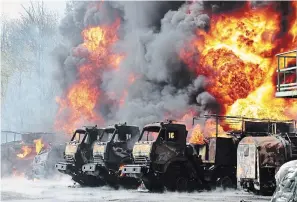  ?? THE ASSOCIATED PRESS ?? Vehicles are on fire at an oil depot after missiles struck the facility in an area controlled by Russian-backed separatist forces in Makiivka, 15 kilometres east of Donetsk, eastern Ukraine, on Wednesday.