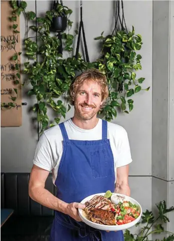  ?? PHOTO: ANNA KUCERA ?? TASTE OF SUMMER: Chef Darren Robertson at Rocker, North Bondi, Sydney, pictured with his harissa butterflie­d lamb leg, smoked eggplant and watermelon radish salad.