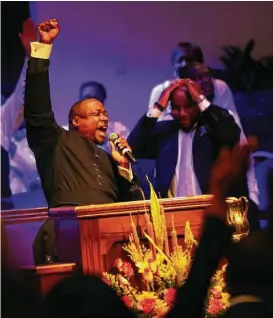  ?? Karen Warren photos / Houston Chronicle ?? The Rev. Marcus Cosby preaches Sunday at Wheeler Baptist Church. “Whenever you attack folks in the body of Christ, it just makes us stronger,” he sermonized.