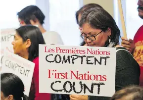  ?? JOHN KENNEY/MONTREAL GAZETTE ?? Brenda Michel of the Innu community of Mingan holds a sign at a news conference of Quebec First Nations chiefs who met in Val-d’Or on Tuesday. They want an independen­t inquiry into allegation­s that Sûreté du Québec officers sexually and physically...