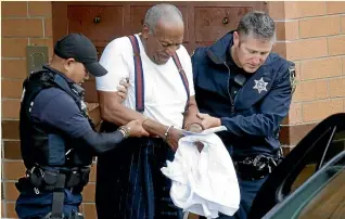  ?? AP ?? Bill Cosby is escorted out of the Montgomery County Correction­al Facility yesterday in Eagleville, Pennsylvan­ia, following his sentencing to three-to-10-years in prison for sexual assault.