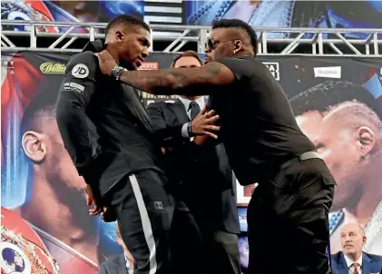  ?? AP ?? Anthony Joshua, left, is shoved by American opponent Jarrell Miller before their New York press conference.