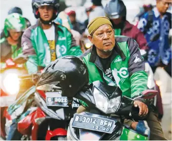  ?? AP ?? IN INDONESIA. In this April 29, 2016, file photo, Go-Jek motorcycle taxi drivers wait for customers in Jakarta, Indonesia.