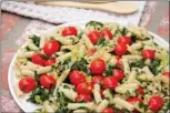  ??  ?? Penne with tomatoes, garlic, lemon and spinach.