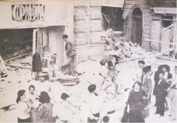  ?? ?? People gather around the old-establishe­d Gopaldas outlet, in Valletta after it was bombed out.