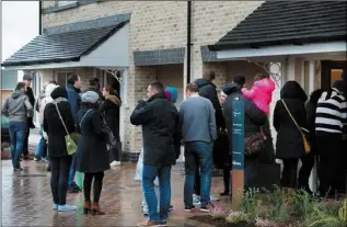  ??  ?? Househunte­rs queue in the bitter cold to view new homes in Portmarnoc­k, Co. Dublin.